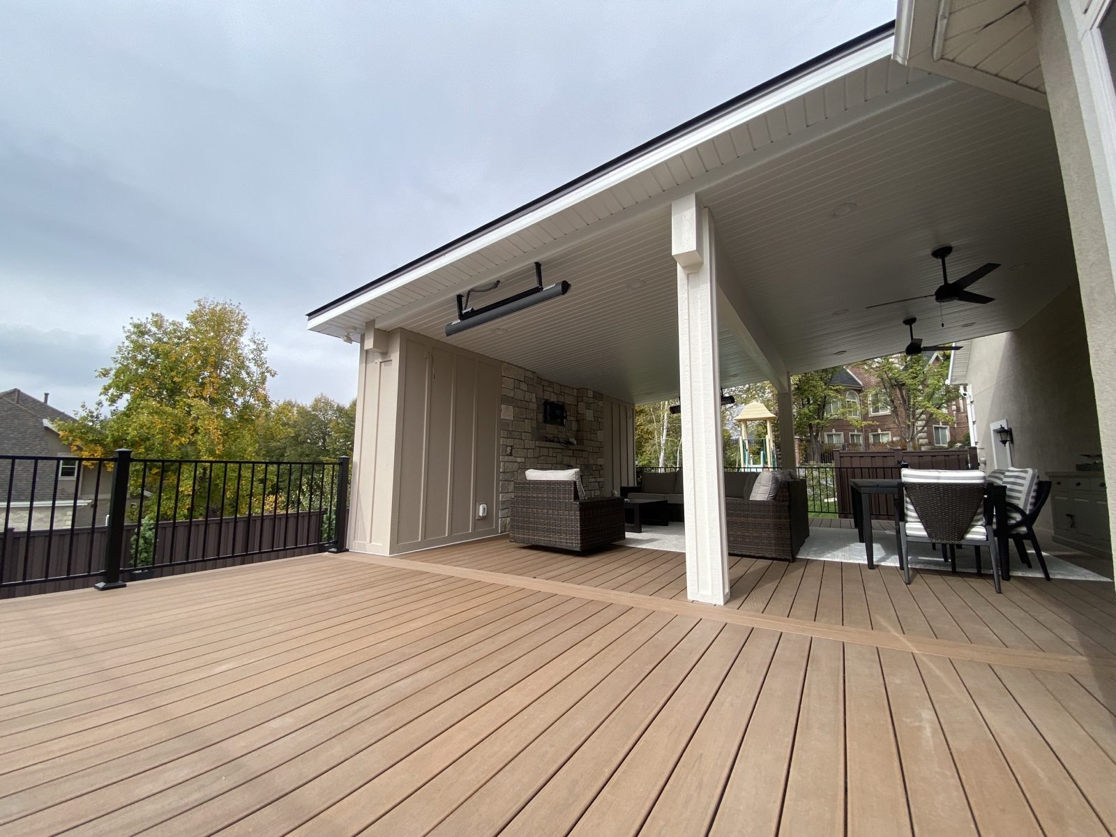 TimberTech decking on a covered patio with a heater and lounge seating