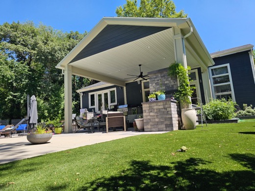 Custom gable roof over a patio with an outdoor kitchen
