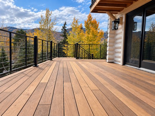 Ipe hardwood deck with black horizontal-rod railing and autumn mountain views