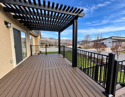 Brown Trex Enhance Naturals deck under a black pergola with mountain views