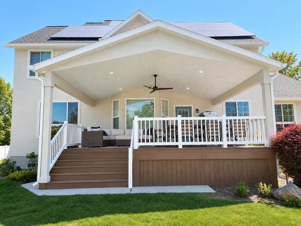 Gabled custom roof over a covered deck with white railing