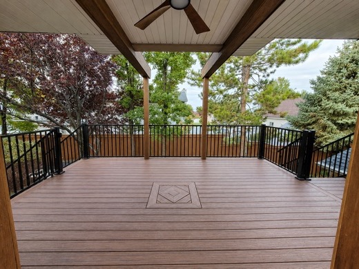 Covered deck with a ceiling fan and a diamond inlay set into the decking
