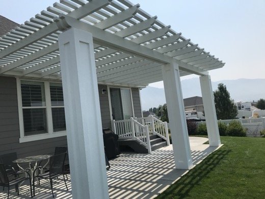 White aluminum pergola over a patio with mountain views