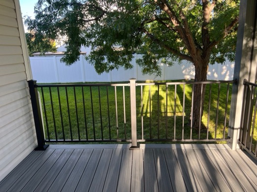 Black aluminum picket railing on a gray composite deck