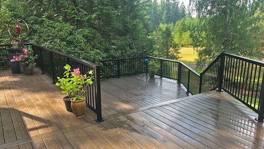 Black aluminum picket railing on a wooded composite deck