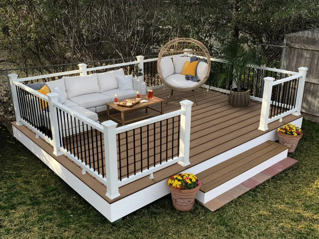 composite deck with composite and aluminum railing. outdoor furniture, decor and snacks on deck.