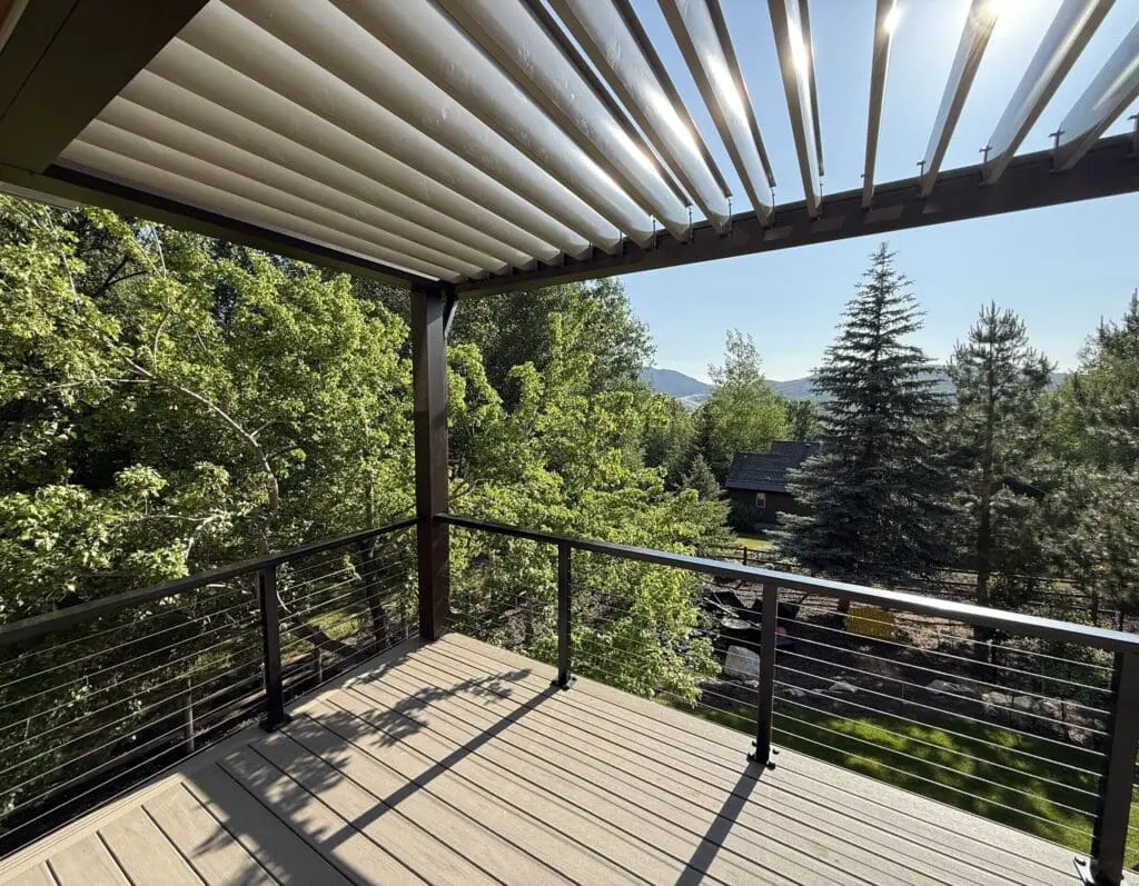 louvered pergola built atop a second story composite deck with an aluminum and steel horizontal railing.