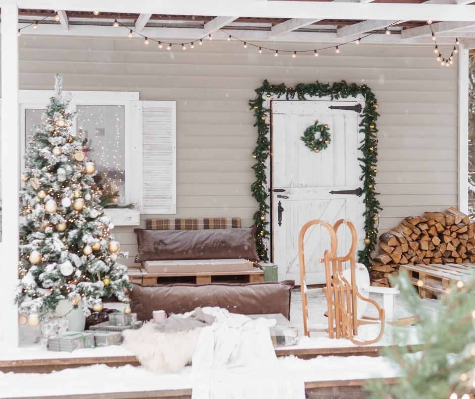 back porch deck area decorated for the holidays with a christmas tree and festive decorations