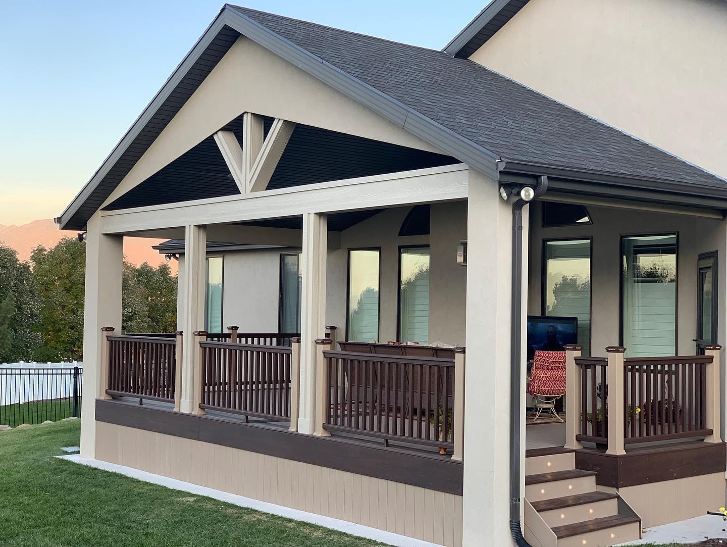 composite deck featuring a custom deck roof and railings