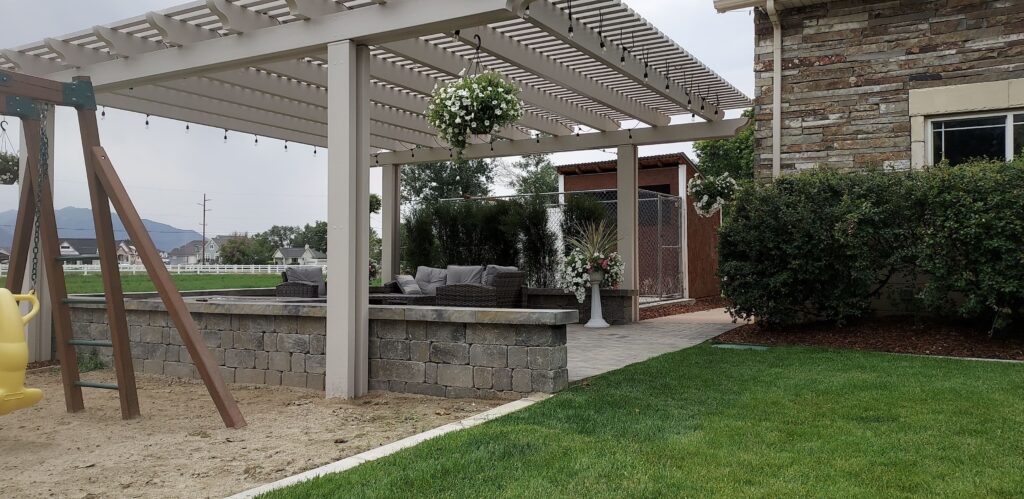 Frees standing pergola that is covering a back patio space.